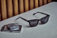Editorial photo shoot featuring Max Pittion eyewear. black eyewear with zippo lighter