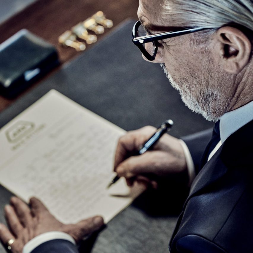 gentleman writing letter, stylish office setting, classic stationary