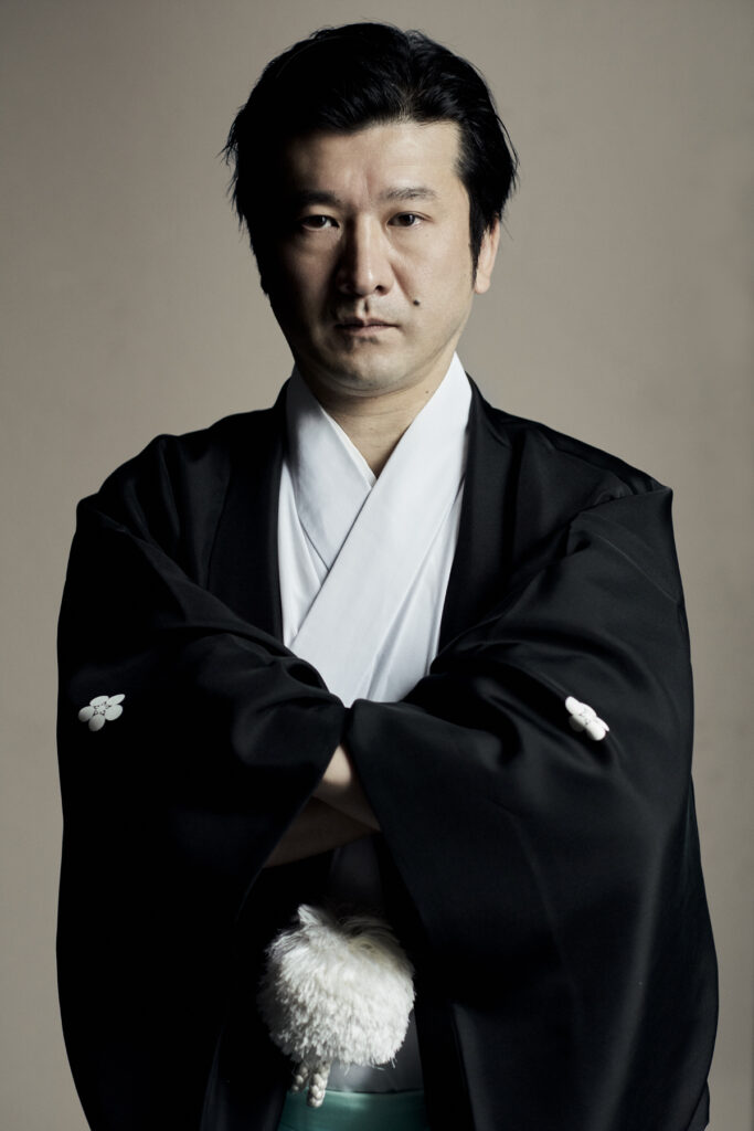 Studio portrait of Masatsugu Okutani in black kimono, Shinto officiant bringing Japanese spiritual practice to Europe